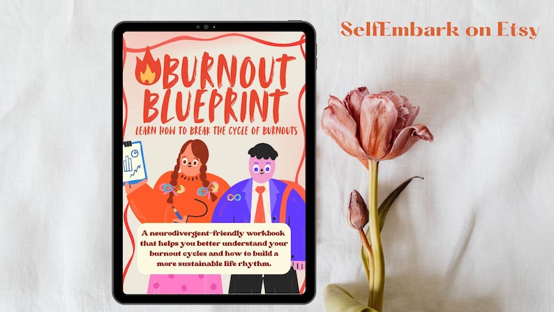 May include: A digital tablet displays a colorful illustration for a workbook titled "Burnout Blueprint." The cover art features cartoon figures and text that reads "Learn How to Break the Cycle of Burnouts." A pink and orange tulip is next to the tablet.