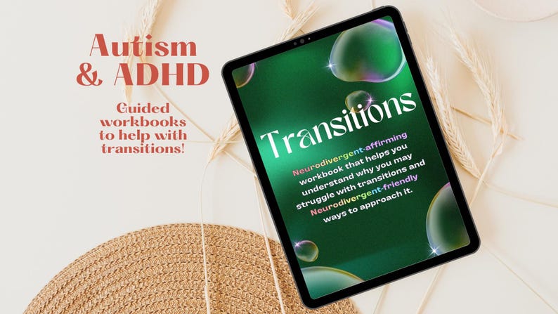 May include: A green digital tablet with a cover that says "Transitions: Neurodivergent-affirming workbook that helps you understand why you may struggle with transitions and Neurodivergent-friendly ways to approach it." The tablet is on a white surface with a straw-coloured woven mat and dried grass.