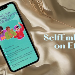 May include: A smartphone screen displaying a graphic with the text "What can Monotropic Focus look like?" and a list of bullet points. The graphic features three cartoon people. The text "SelfEmbark on Etsy" is visible on a beige fabric background.