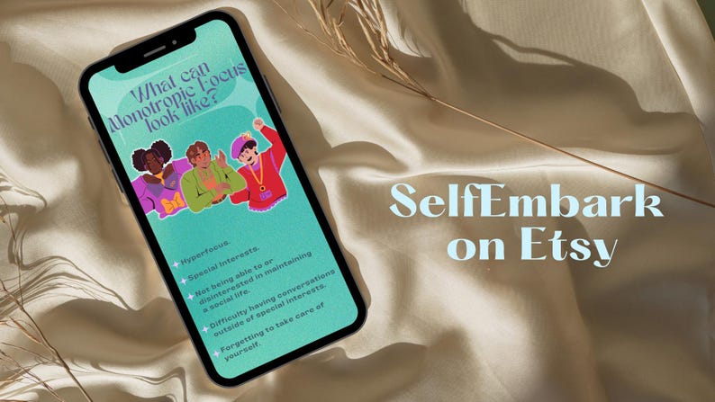 May include: A smartphone screen displaying a graphic with the text "What can Monotropic Focus look like?" and a list of bullet points. The graphic features three cartoon people. The text "SelfEmbark on Etsy" is visible on a beige fabric background.