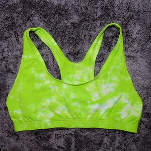 May include: A green and white tie-dye sports bra with a racerback style.