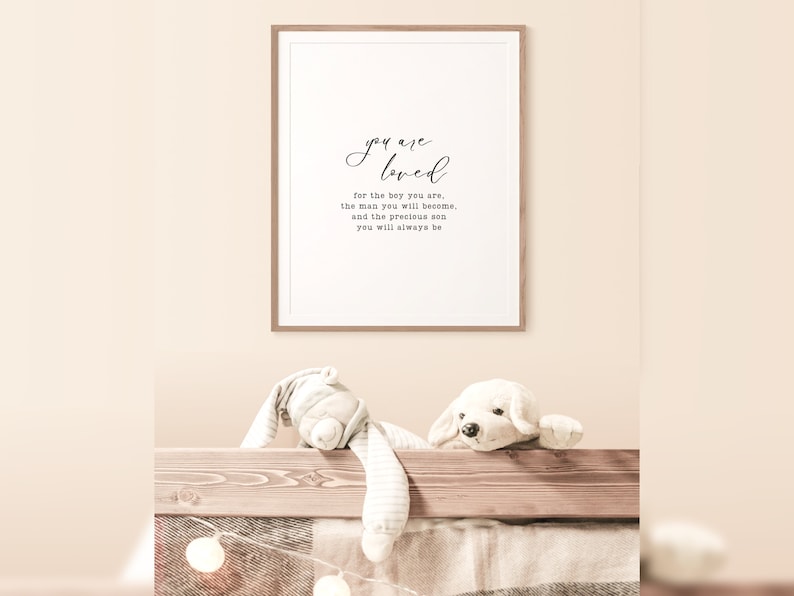 Peut inclure: Une impression encadr&eacute;e avec un fond blanc et du texte noir qui dit "you are loved for the boy you are, the man you will become, and the precious son you will always be."