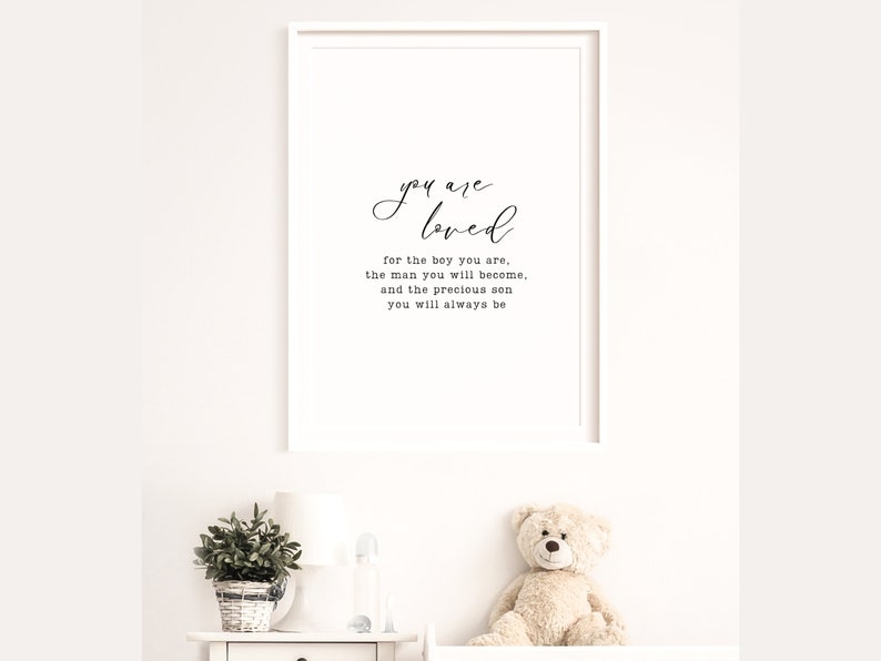 Peut inclure: Une impression encadr&eacute;e blanche avec le texte "you are loved" et le texte suivant en dessous : "for the boy you are, the man you will become, and the precious son you will always be."