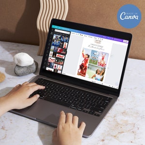 May include: A laptop screen showing a digital cheerleading planner with the text "Cheer Planner". The words "Edit Everything" and "Digital Download" are printed on the side. The laptop is on a marble surface. The image also says "Made in Canva".
