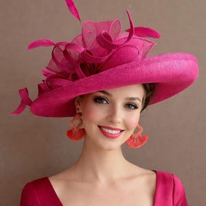May include: A vibrant fuchsia hat with a wide brim and decorative accents, including feathers and sheer fabric. The hat is paired with matching fuchsia earrings with orange fringe. The woman is wearing a fuchsia dress.