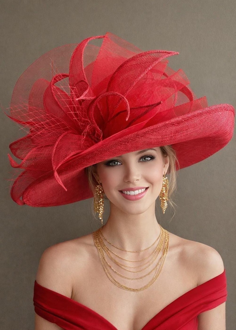 May include: A vibrant red hat with a wide brim and decorative accents. The hat features a layered design with a mesh veil and is paired with gold jewelry. The overall look is elegant and suitable for special occasions.