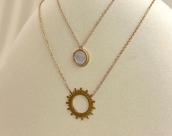 Double necklace in fine stainless steel with pearlescent medallion and sun