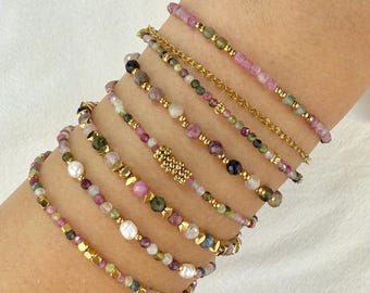 Stainless steel bracelet with natural tourmaline gemstones in various colors and gold charms.