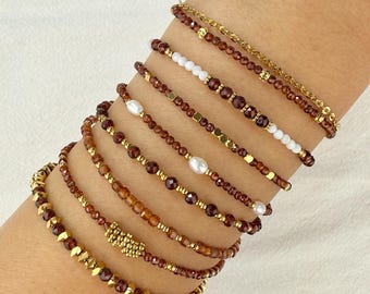 Stainless steel bracelet with natural orange garnet gemstones and gold charms