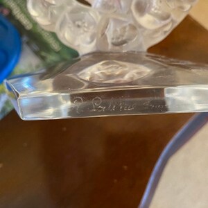 K&ouml;nnte beinhalten: Eine klare Glasskulptur mit floralem Design. Die Basis der Skulptur ist ein klares Glasoktagon mit der Inschrift "Baccarat France" auf der Unterseite.