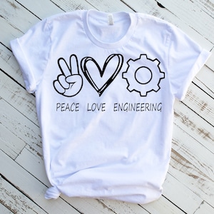 May include: White t-shirt with a black peace sign, heart, and gear graphic. The text "Peace Love Engineering" is printed below the graphic.