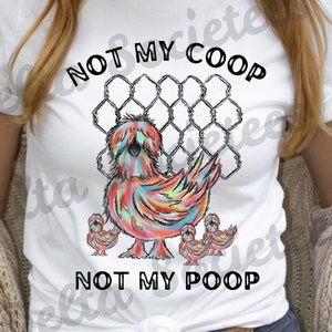 May include: White t-shirt featuring a colorful chicken graphic with the text "NOT MY COOP NOT MY POOP". The chicken is depicted with a rainbow of colors, and the design includes a wire fence and three smaller chicks.