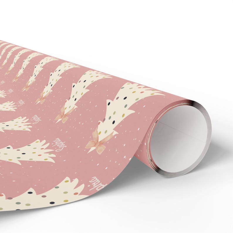 May include: Pink wrapping paper with a repeating pattern of white Christmas trees with gold, black, and green polka dots. The trees have a pink bow on top. The text "Merry" and "Bright" is printed on the paper.