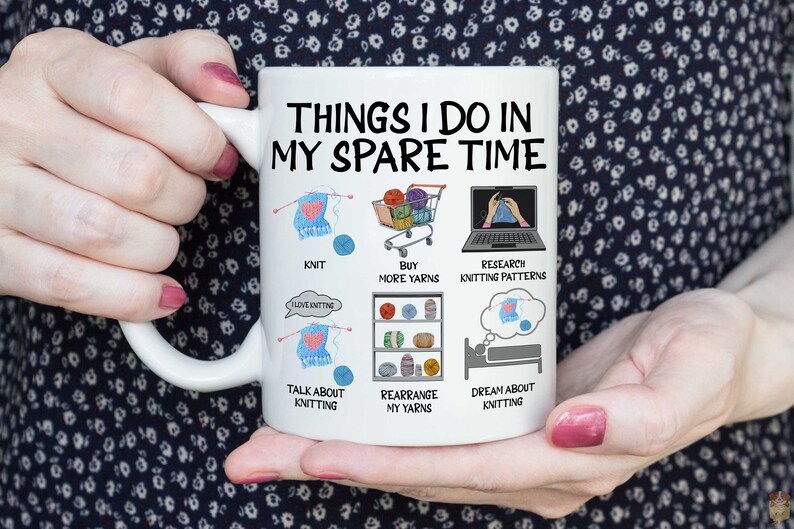 May include: White ceramic mug with a black and white illustration of things to do in your spare time, including knitting, buying yarn, researching knitting patterns, talking about knitting, rearranging yarn, and dreaming about knitting.