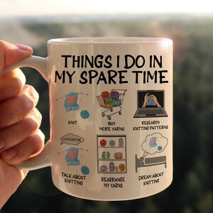 May include: White ceramic mug with a black and white illustration of knitting-related activities. The text on the mug reads "Things I do in my spare time".