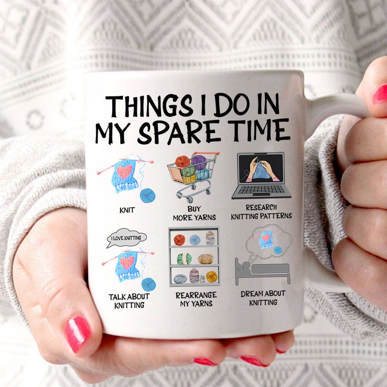 May include: White ceramic mug with a black and white illustration of a knitting theme. The text on the mug reads "Things I do in my spare time". The illustration shows a person knitting, buying yarn, researching knitting patterns, talking about knitting, rearranging yarn, and dreaming about knitting.