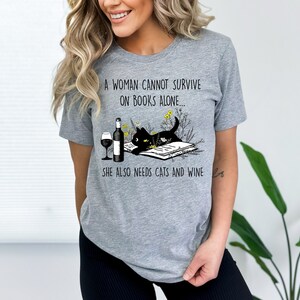 Funny Book Shirt Vintage Cat Lover Shirt A Woman Cannot Survive On Books Alone She Also Needs Cats And Wine Book Lover Shirt Wine Love Shirt