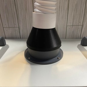 May include: A white, flexible hose with a black and gray adapter. The adapter has a flared opening and a flat base.