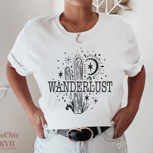 May include: White t-shirt with a black cactus and stars graphic and the text "WANDERLUST".