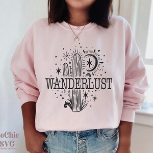 May include: A pink sweatshirt with a black cactus graphic and the text "WANDERLUST".
