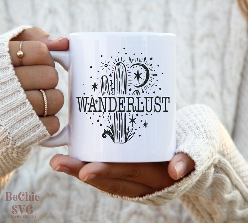May include: White ceramic mug with a black and white illustration of a cactus, moon, stars, and the word "WANDERLUST".