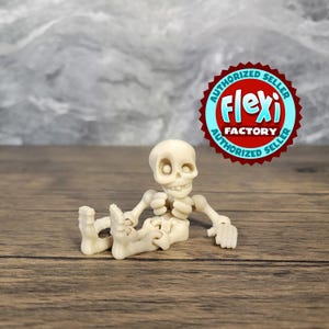 May include: A white articulated skeleton figurine with a friendly expression, sitting with its legs crossed and arms folded. The figurine is made of a flexible plastic material.