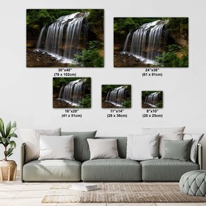 May include: A photograph of a waterfall in a forest. The waterfall is flowing over rocks and into a pool of water. The image is available in various sizes, from 8 inches by 10 inches to 30 inches by 40 inches.