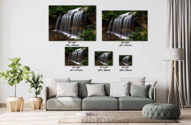 May include: A photograph of a waterfall in a forest. The waterfall is flowing over rocks and into a pool of water. The image is available in various sizes, from 8 inches by 10 inches to 30 inches by 40 inches.