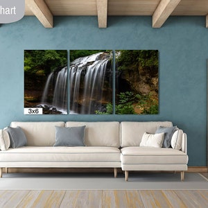 May include: A three-panel canvas print of a waterfall in a forest. The print is hanging on a wall in a living room with a white couch and a wooden door. The text "3x6" is printed below the canvas.