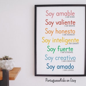 May include: A framed print with the Spanish phrase "Soy..." repeated seven times, each time with a different color and a different English translation. The translations are "I am kind", "I am brave", "I am honest", "I am smart", "I am strong", "I am creative", and "I am loved".