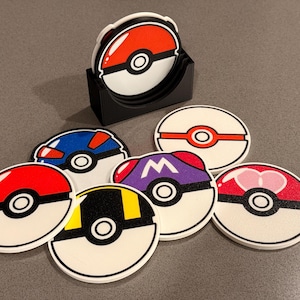 May include: Set of seven colorful round coasters featuring different Pokemon characters. Each coaster has a white background with a black outline and a red, blue, or purple center. The coasters are made of a durable material and are perfect for protecting your furniture from spills and scratches.