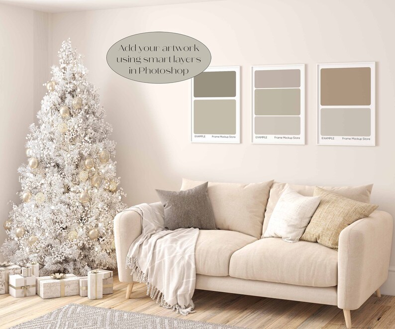 May include: A white Christmas tree with gold ornaments sits next to a beige couch with pillows and a throw blanket. Three framed artwork mockups are on the wall behind the couch. The text "Add your artwork using smart layers in Photoshop" is written on the wall.