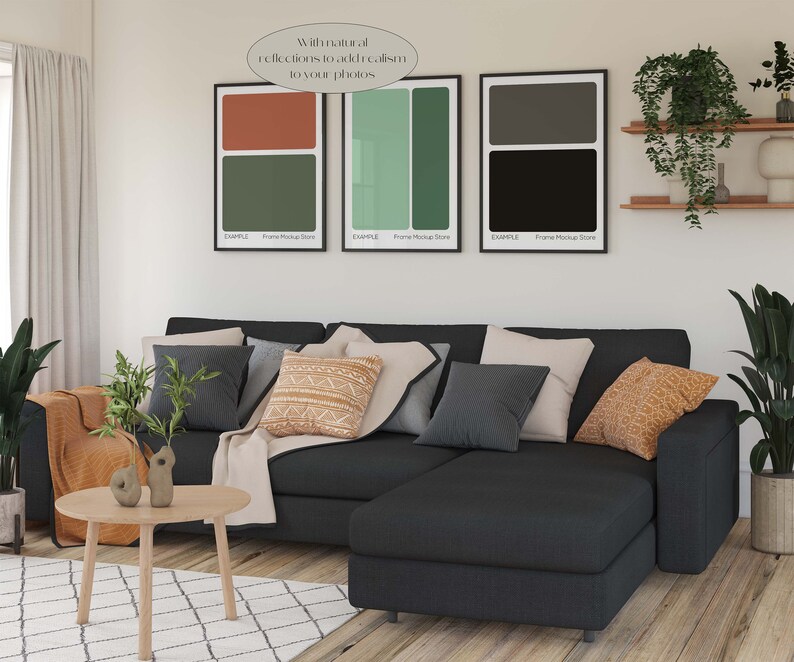 May include: A black sectional sofa with a variety of throw pillows in a living room setting. The sofa is in front of a white wall with three framed abstract art prints. The prints are in black, green, and brown colours. The text on the prints reads "With natural reflections to add realism to your photos."  "EXAMPLE Frame Mockup Store"