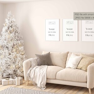 May include: A white couch with three pillows, a white throw blanket, and a white Christmas tree with gold ornaments in a living room setting. Three white picture frames with the text "Your Artwork Here" are hanging on the wall.