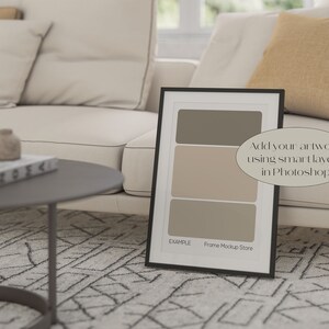 May include: A black picture frame mockup with a white mat and a light brown background. The frame is sitting on a white couch with a brown throw pillow. The text "Add your artwork using smart layers in Photoshop" is written on the image. The text "EXAMPLE Frame Mockup Store" is at the bottom of the frame.