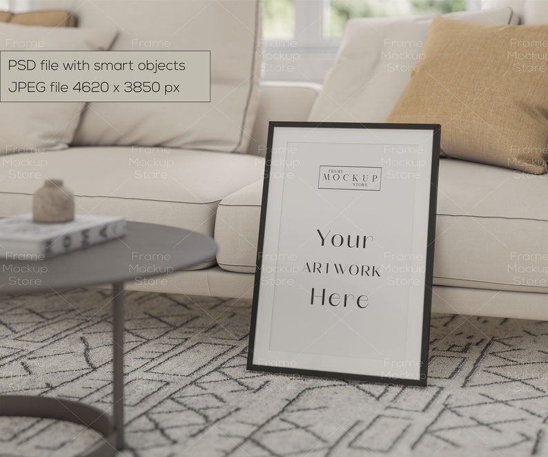 May include: A black picture frame with a white mat and a white background. The frame is sitting on a white couch with a brown throw pillow. The text "Your Artwork Here" is printed in black on the white background.