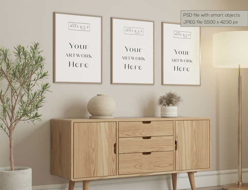 May include: Three framed art prints with the text "Your Artwork Here" hang above a wooden cabinet. A decorative vase and potted plant sit on the cabinet. A floor lamp and a potted plant are also in the scene.