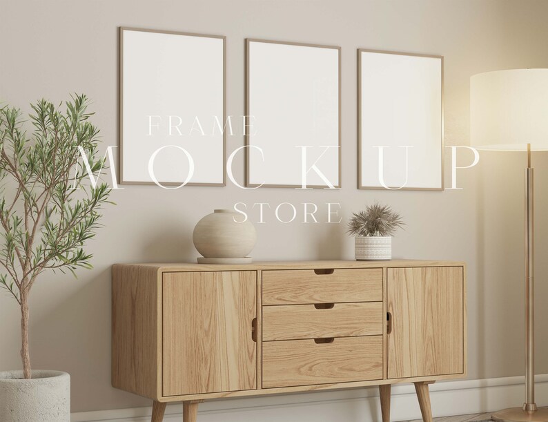 May include: Three framed art mockups with a light wood finish hang above a wooden cabinet. A small potted plant and a decorative vase sit on the cabinet. The text "FRAME MOCKUP STORE" is overlaid on the image.