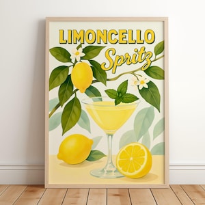 May include: Framed print with a Limoncello Spritz design. The artwork depicts a yellow cocktail in a glass, lemons, mint, and the words "Limoncello Spritz" in a vintage style. The print is in a wooden frame.