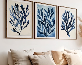 May include: Three framed watercolor prints of blue botanical illustrations. The prints feature a variety of blue leafy branches and a coral-like branch.