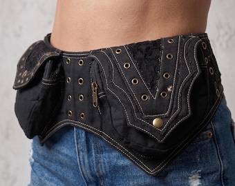 May include: Black waist bag with multiple compartments, featuring a decorative lace panel and brass-colored grommets. The bag has a zipper closure and is worn with denim shorts.