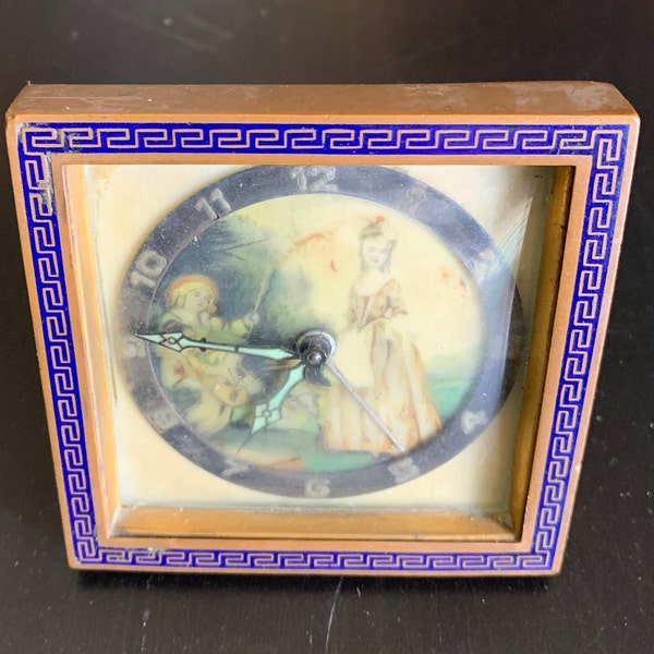 Vintage table clock framed with blue meander pattern