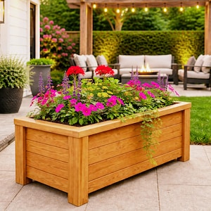 DIY raised planter box woodworking plans featuring a modern outdoor wooden planter with sturdy legs and clean horizontal slat design. Perfect for garden, patio, or backyard projects, this build showcases a durable and stylish raised garden bed ideal for flowers, herbs, or vegetables. Step-by-step DIY woodworking plans suitable for beginners and intermediate woodworkers looking to create a functional and decorative planter box.