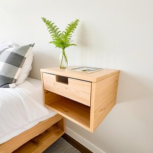 Here is a floating nightstand made of wood placed on the wall in the bedroom. It can also be used in the living room, living room.

Overall Dimensions:
H 10.75 inch, L 16.5 inch, D 14 inch