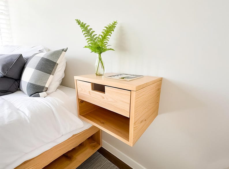 Here is a floating nightstand made of wood placed on the wall in the bedroom. It can also be used in the living room, living room.

Overall Dimensions:
H 10.75 inch, L 16.5 inch, D 14 inch