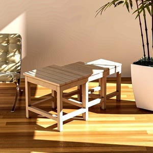 Here, there is a nestable End Table-Side Table or Nesting Coffee Table set consisting of 3 pieces, Large, Medium and Small, placed indoors.