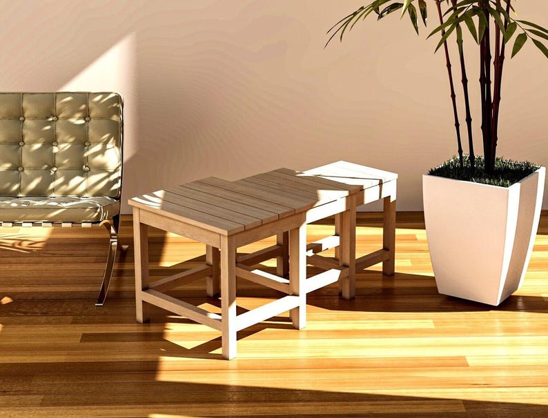 Here, there is a nestable End Table-Side Table or Nesting Coffee Table set consisting of 3 pieces, Large, Medium and Small, placed indoors.
