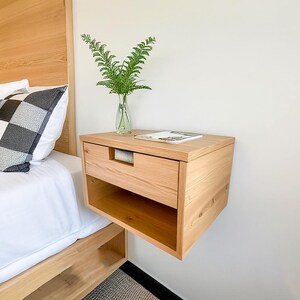 Here is a floating nightstand made of wood placed on the wall in the bedroom. It can also be used in the living room, living room.

Overall Dimensions:
H 10.75 inch, L 16.5 inch, D 14 inch