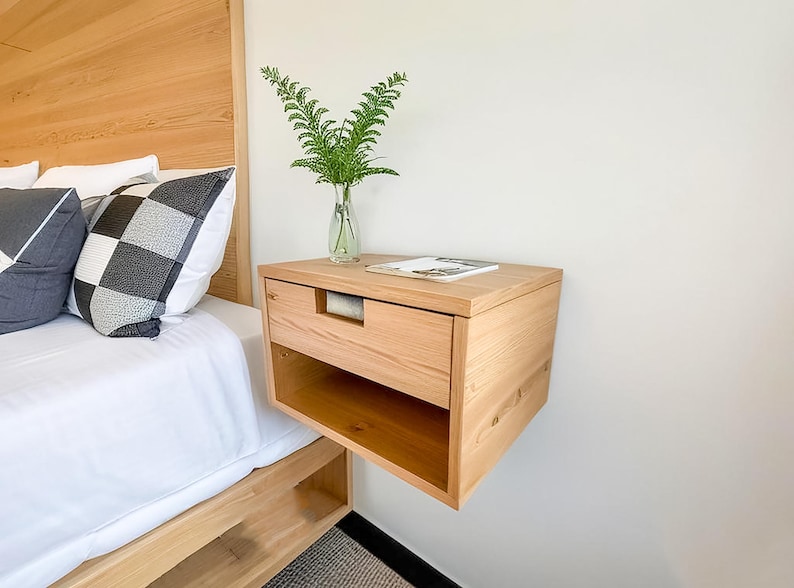 Here is a floating nightstand made of wood placed on the wall in the bedroom. It can also be used in the living room, living room.

Overall Dimensions:
H 10.75 inch, L 16.5 inch, D 14 inch