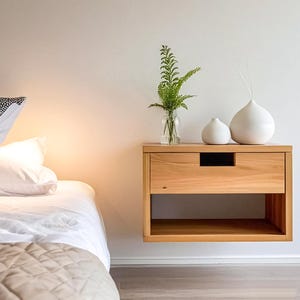 Here is a floating nightstand made of wood placed on the wall in the bedroom. It can also be used in the living room, living room.

Overall Dimensions:
H 10.75 inch, L 16.5 inch, D 14 inch
